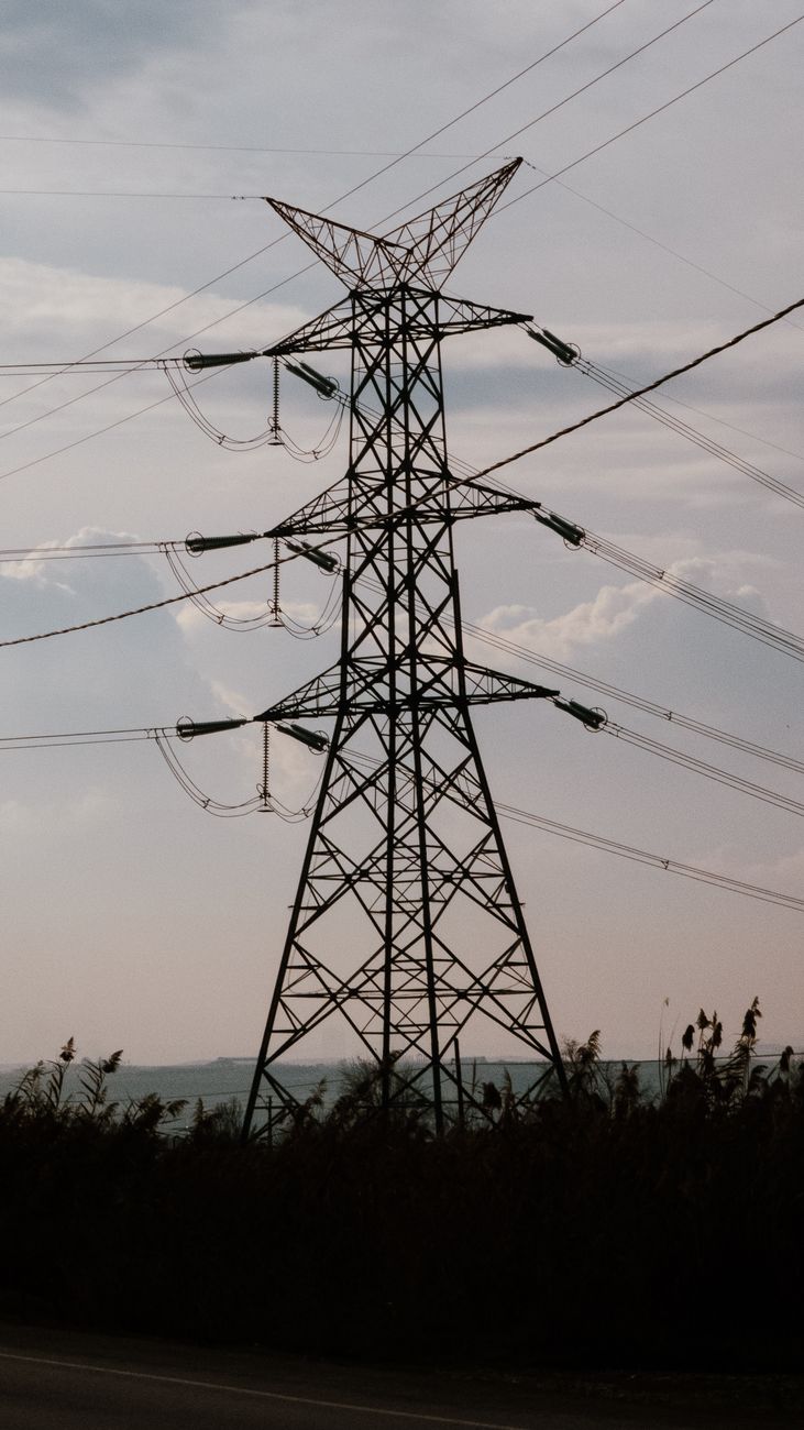 high voltage power lines against sky